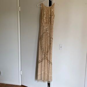 A very beautiful sequin gold special occasion backless to the floor dress.